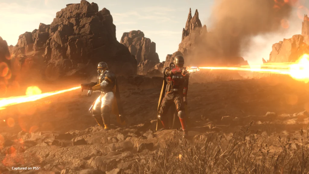 Two Helldivers using weapons and armor from the Freedom's Flame Warbond to fight off enemies