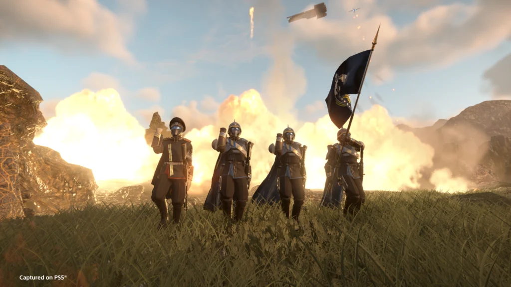 Four Helldivers marching victoriously with the flag of Super Earth in hand