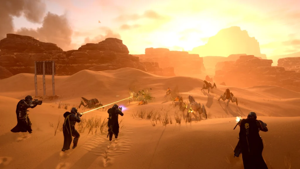 Four Helldivers fighting off a group of Terminids