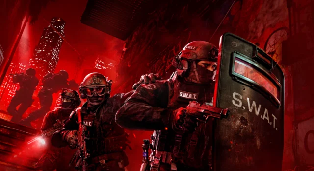 Four SWAT officers behind another officer with a riot shield