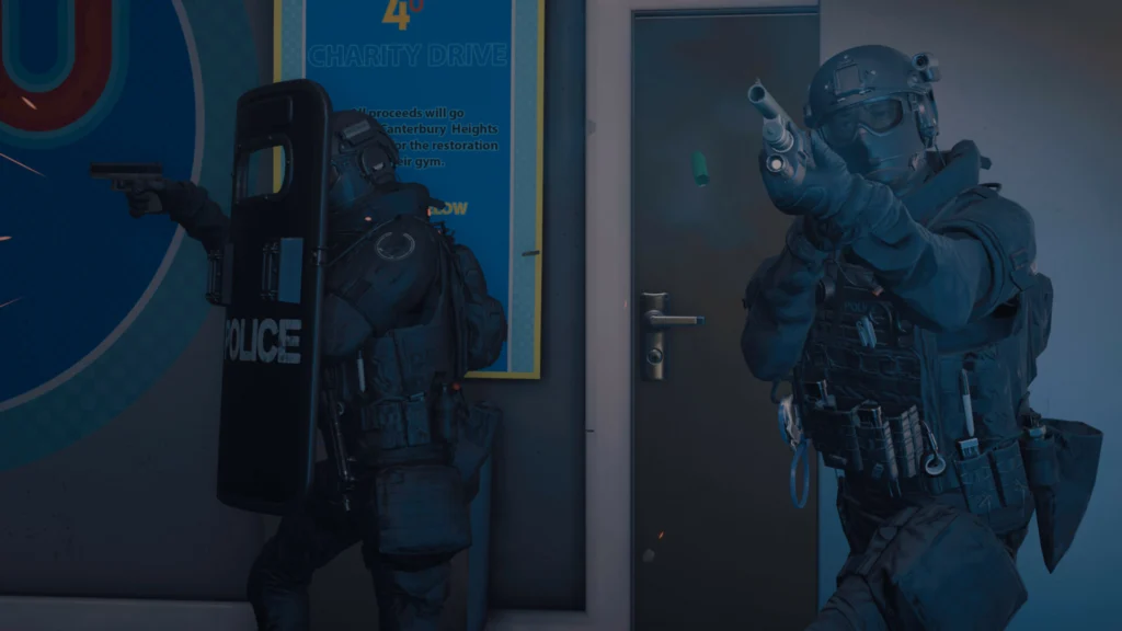 One SWAT officer with a riot shield on the left with an officer with a shotgun on the right