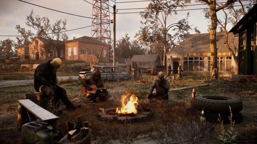 The Stalker 2 1.7 Update And Its Exciting Additions 2 Stalkers sitting around a fire in a dilapidated town