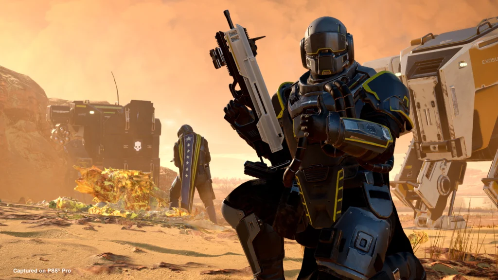 A Helldiver wearing the latest gear and using an emote to kneel down and give a thumbs up from the Helldivers 2 Exo Experts Warbond