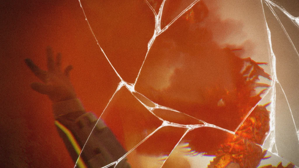 A teaser image showing a cracked screen and a Helldiver's hand on the screen with a hidden threat in the background