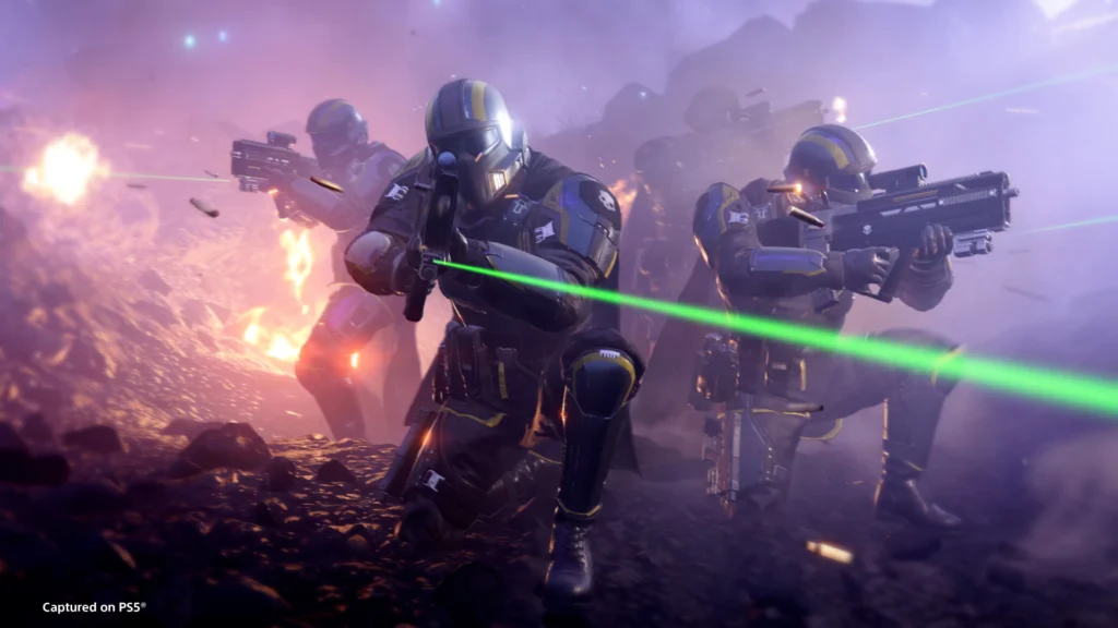 Four Helldivers huddled together while aiming their weapons around them